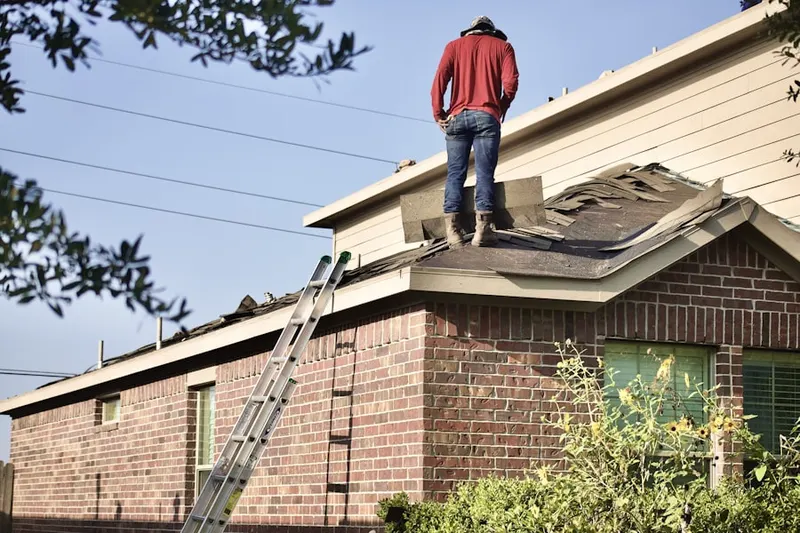 Professional roofer working on a residential roof in Dakota Ridge